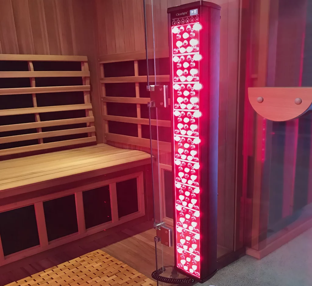 Medium shot of a Red Light Therapy tower set up inside an infrared sauna. Red Light Therapy is a method that enhances sauna benefits.