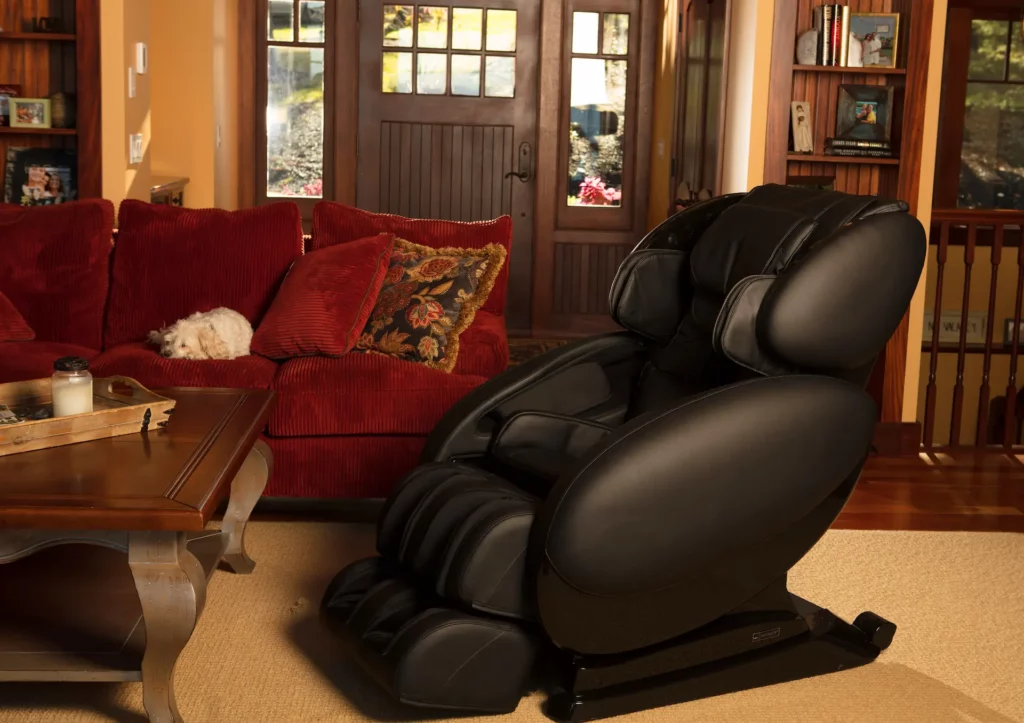 Medium profile shot of a black leather Infinity Massage Chair set up in a well-decorated living room. "How often should I use my massage chair," is one of the most common questions posed by owners of chairs like these.