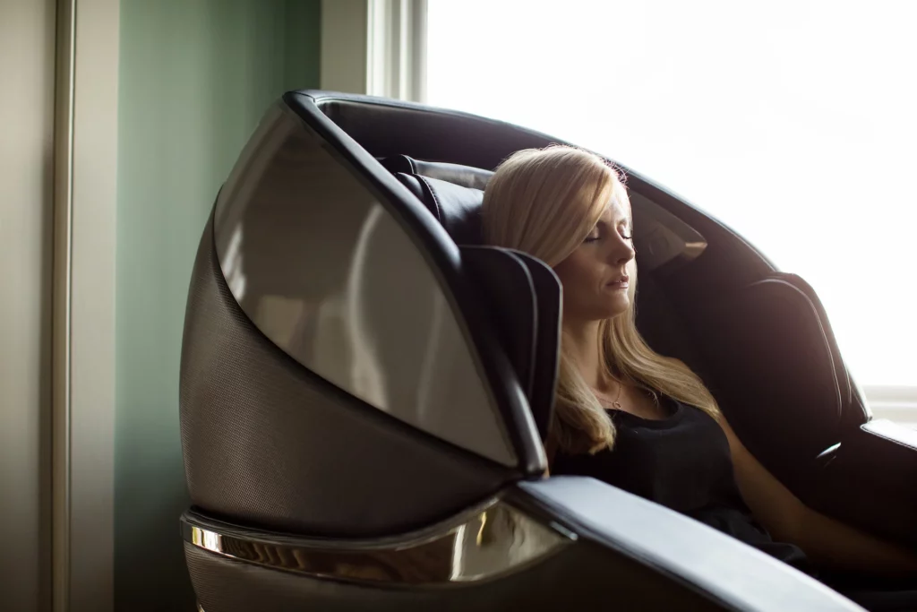 Medium profile shot of a person meditating in a luxury massage chair. Wellness goals like meditation are enhanced by products such as massage chairs.