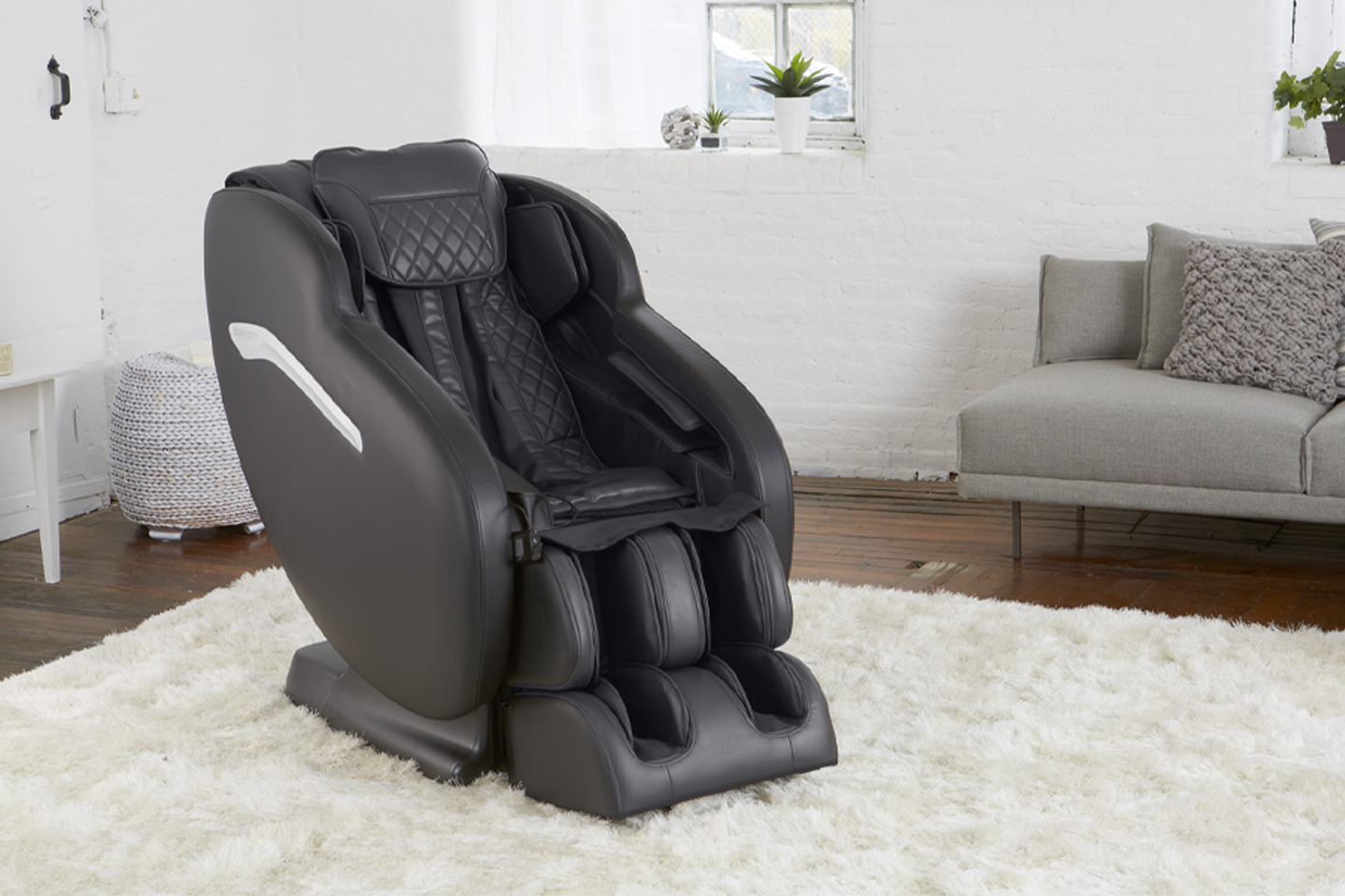 black massage chair on a white run in a living room