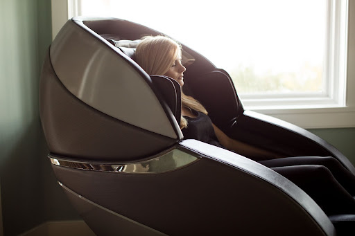 woman sits in massage chair to help with chronic pain